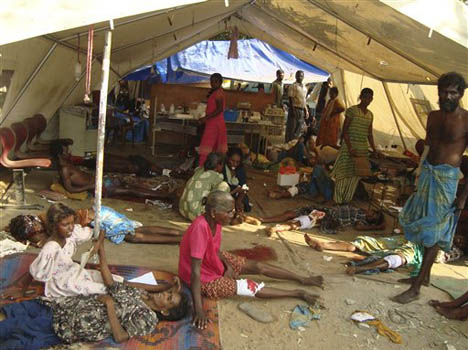 Photographs: Above, civilians shelter from Sri Lankan military attacks pictured on May 4th 2009.