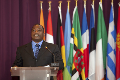 Kabila standing at podium in front of flags 